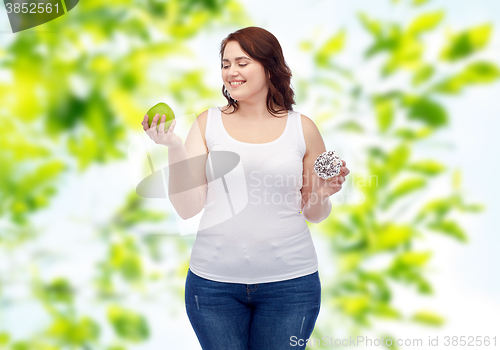 Image of happy plus size woman choosing apple or donut