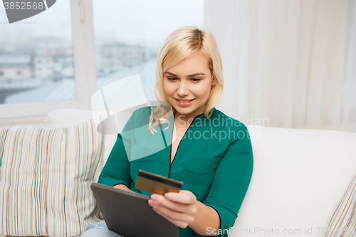 Image of happy woman with tablet pc and credit card