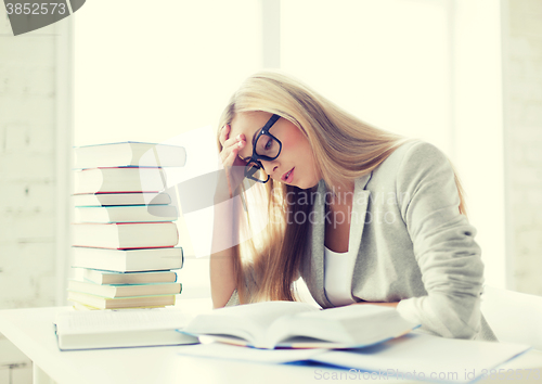 Image of student with books and notes