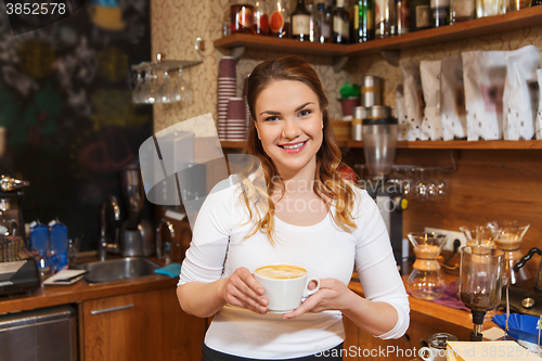 Image of happy barista woman with latte at coffee shop