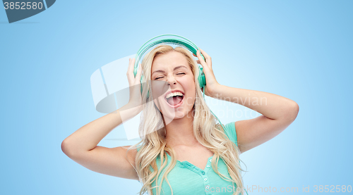 Image of happy young woman or teenage girl with headphones