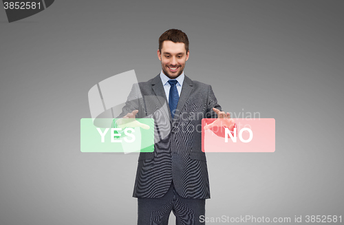 Image of smiling businessman with yes and no buttons