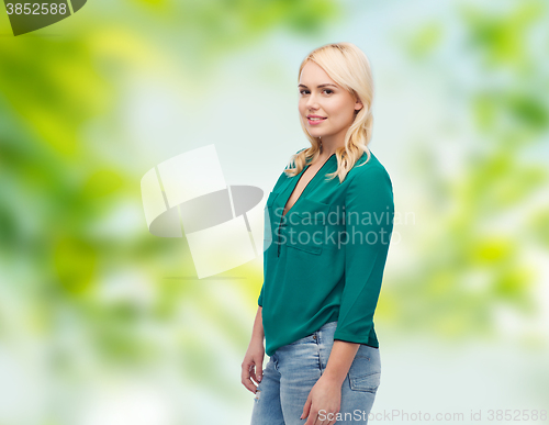 Image of smiling young woman in shirt and jeans