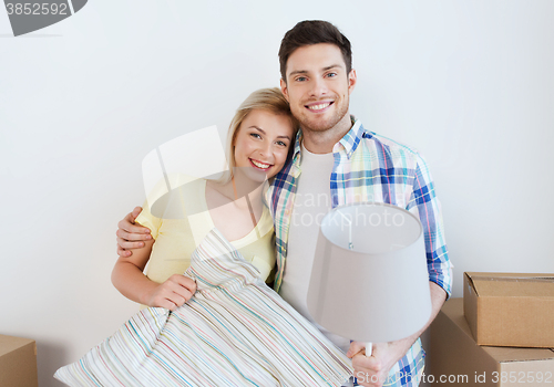 Image of happy couple with stuff moving to new home