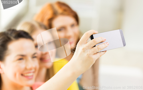 Image of close up of friends taking selfie with smartphone