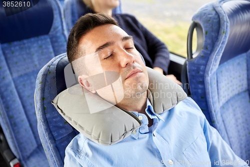 Image of man sleeping in travel bus with cervical pillow