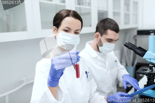 Image of young scientists making test or research in lab