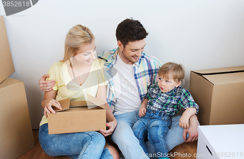 Image of happy family with boxes moving to new home