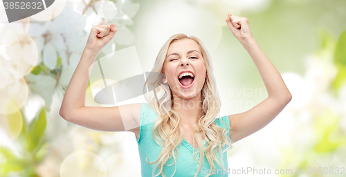 Image of happy young woman or teen girl celebrating victory