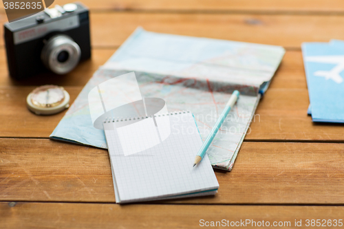 Image of close up of notepad with map and travel tickets