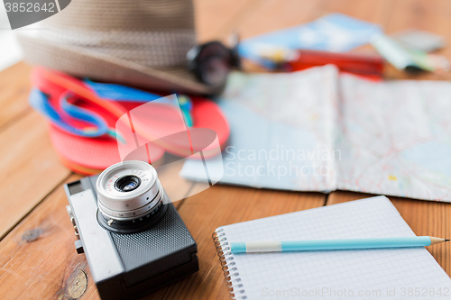Image of close up of camera, notepad and travel stuff
