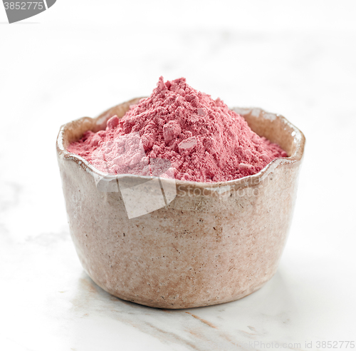 Image of bowl of pink dried berries fruit powder