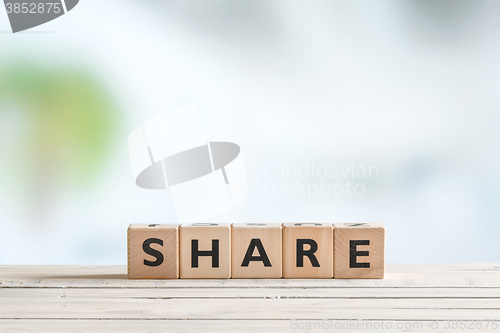 Image of Share word on a wooden table