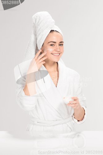 Image of Cute nice girl with cream in her face
