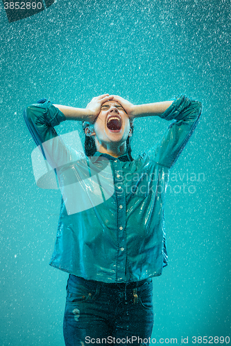 Image of The portrait of young beautiful woman in the rain