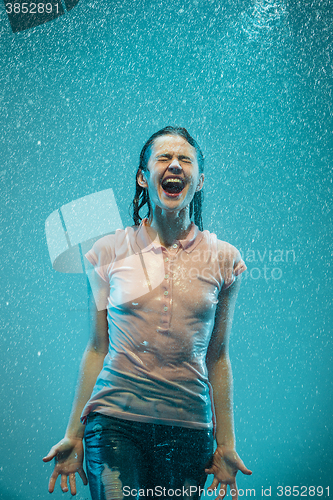 Image of The portrait of young beautiful woman in the rain