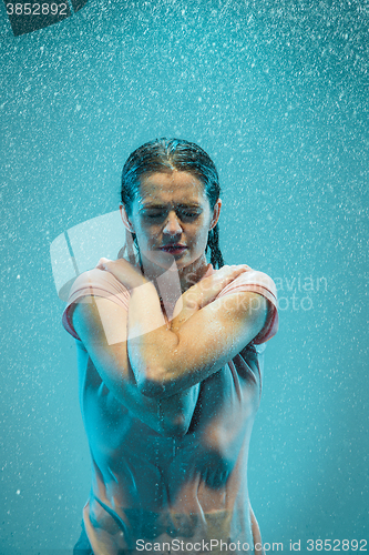 Image of The portrait of young beautiful woman in the rain