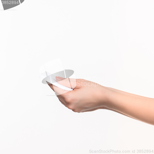 Image of Female hand holding blank paper for records on white.