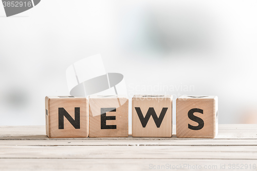 Image of Wooden news sign on a table