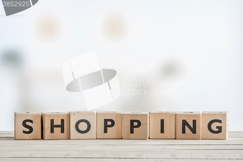 Image of Shopping sign on a wooden table