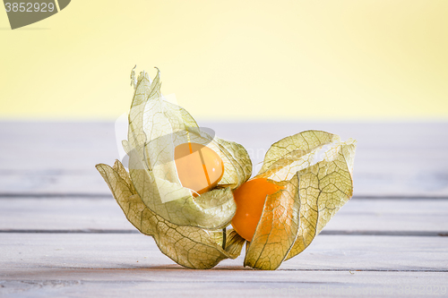 Image of Cape gooseberries on a wooden desk