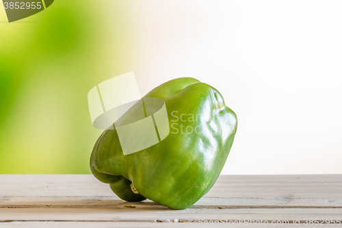 Image of Green pepper on a wooden table