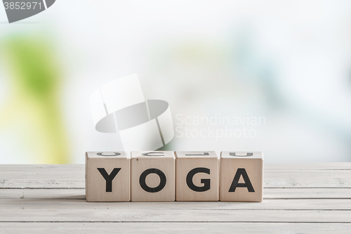 Image of Yoga sign on a wooden desk