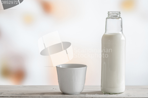 Image of Milk bottle and a cup