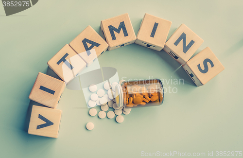 Image of The word vitamins on a table