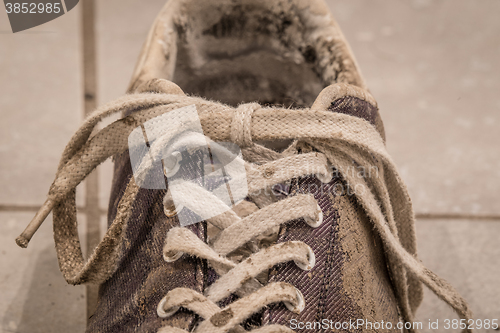 Image of Close-up of laces on a dirty shoe