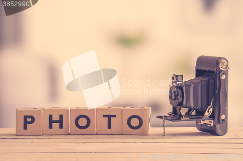 Image of Photo sign with a vintage camera