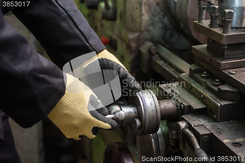 Image of worker in protective gloves