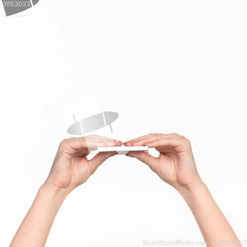 Image of Female hand holding blank paper for records on white.