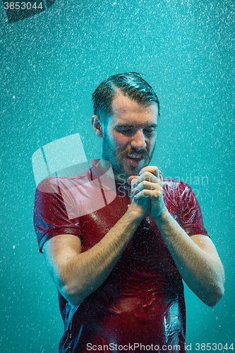 Image of The portrait of young man in the rain