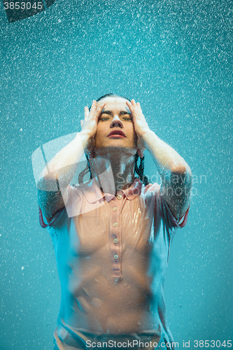 Image of The portrait of young beautiful woman in the rain