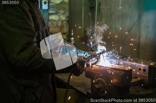 Image of worker welding metal