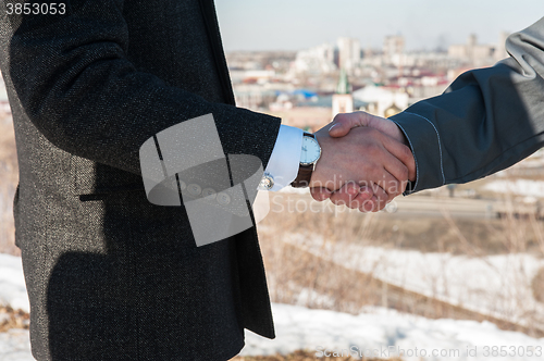 Image of worker shakes hands with businessman