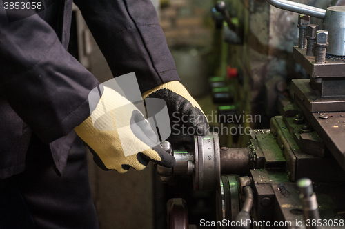 Image of worker in protective gloves