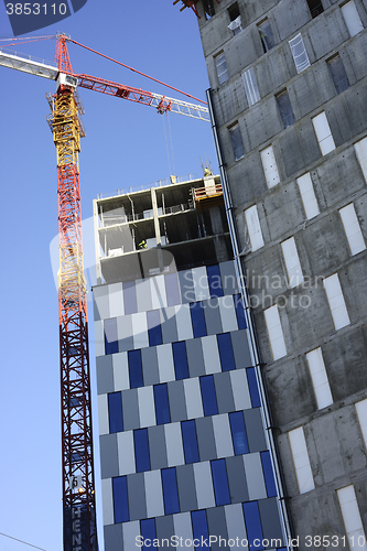 Image of building  with crane against the blue sky