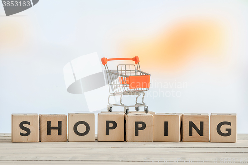 Image of Shopping sign with a orange cart