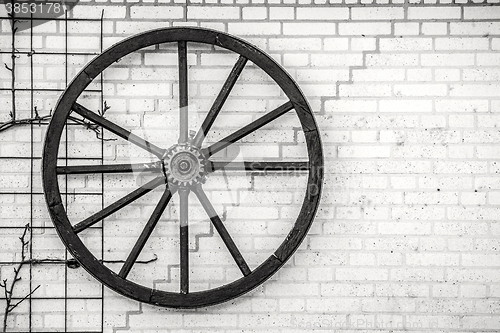 Image of Old wheel hanging on a wall