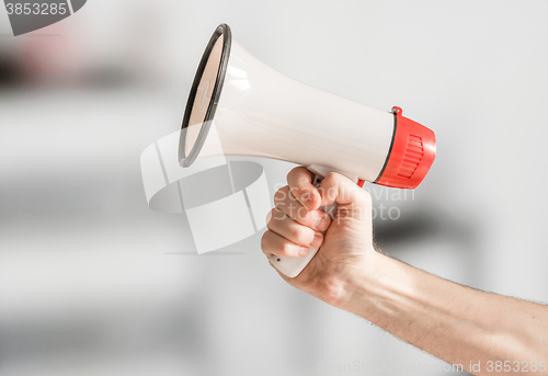 Image of Hand holding a megaphone