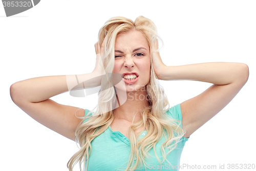 Image of young woman holding to her head and screaming