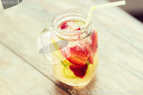 Image of close up of fruit water in glass bottle