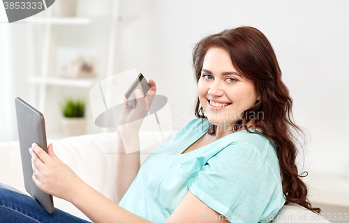 Image of plus size woman with tablet pc and credit card