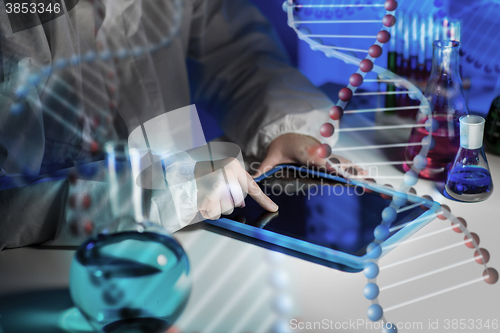 Image of close up of scientist with tablet pc in laboratory