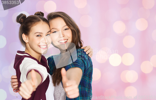 Image of happy smiling teenage girls showing thumbs up