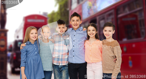 Image of happy smiling children hugging over london city