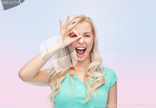 Image of young woman making ok hand gesture