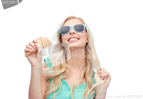 Image of happy young woman in sunglasses eating ice cream